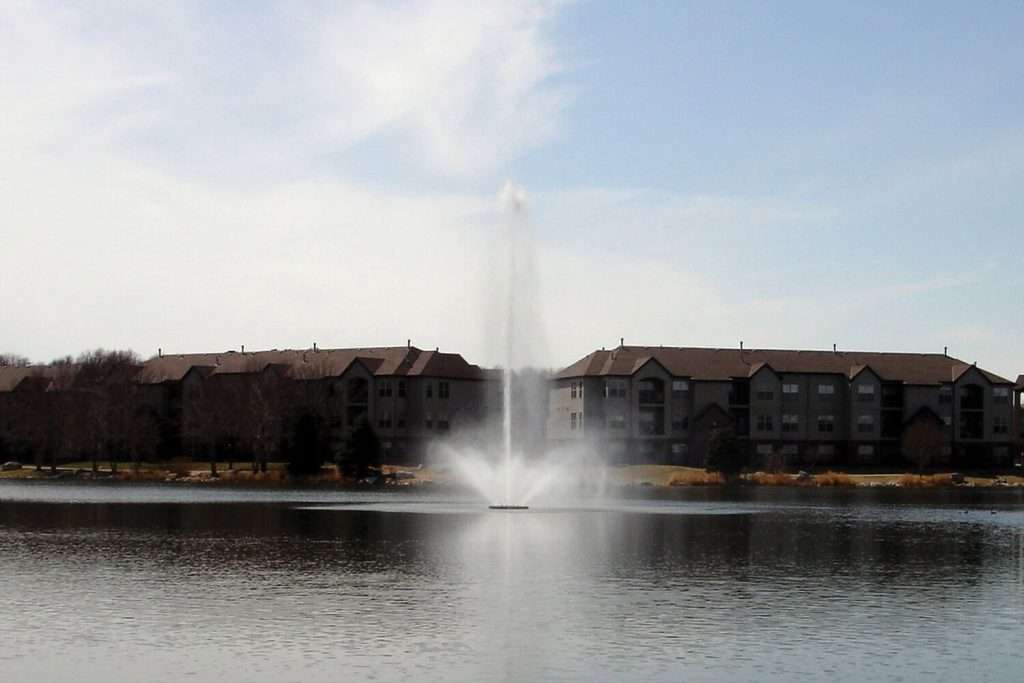 Otterbine Aquastar fountain in a residential lake with tall vertical spray