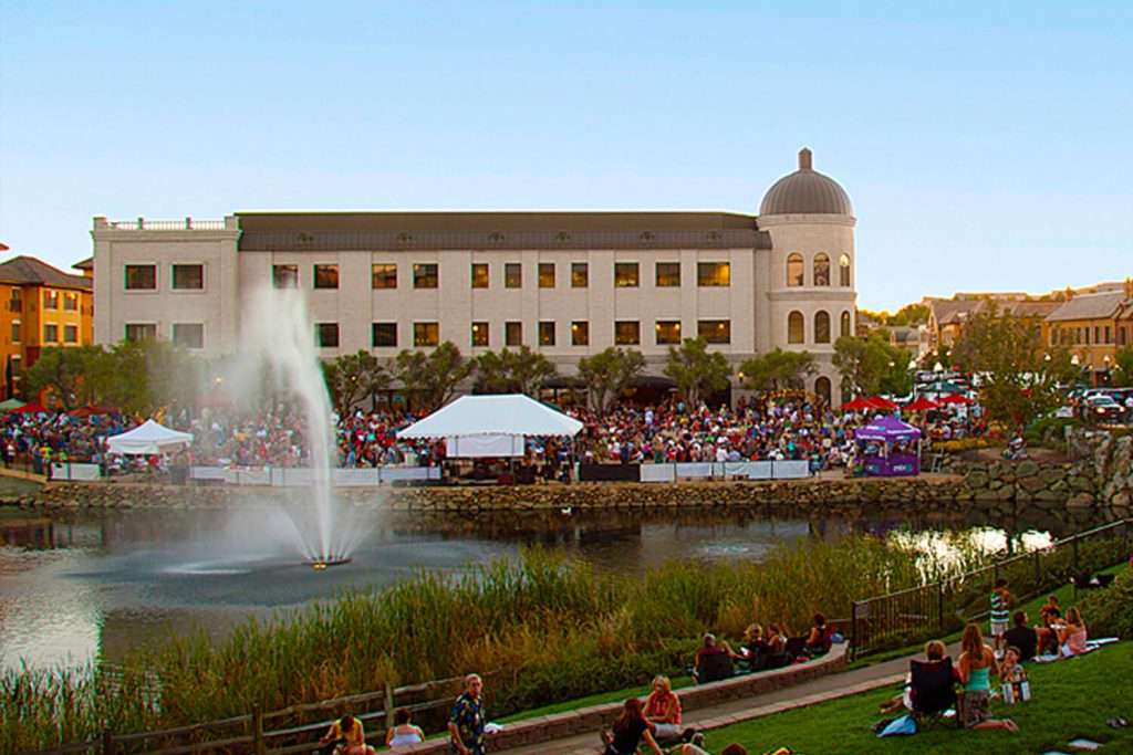 Otterbine Aquastar fountain aerating a pond in front of a large event crowd