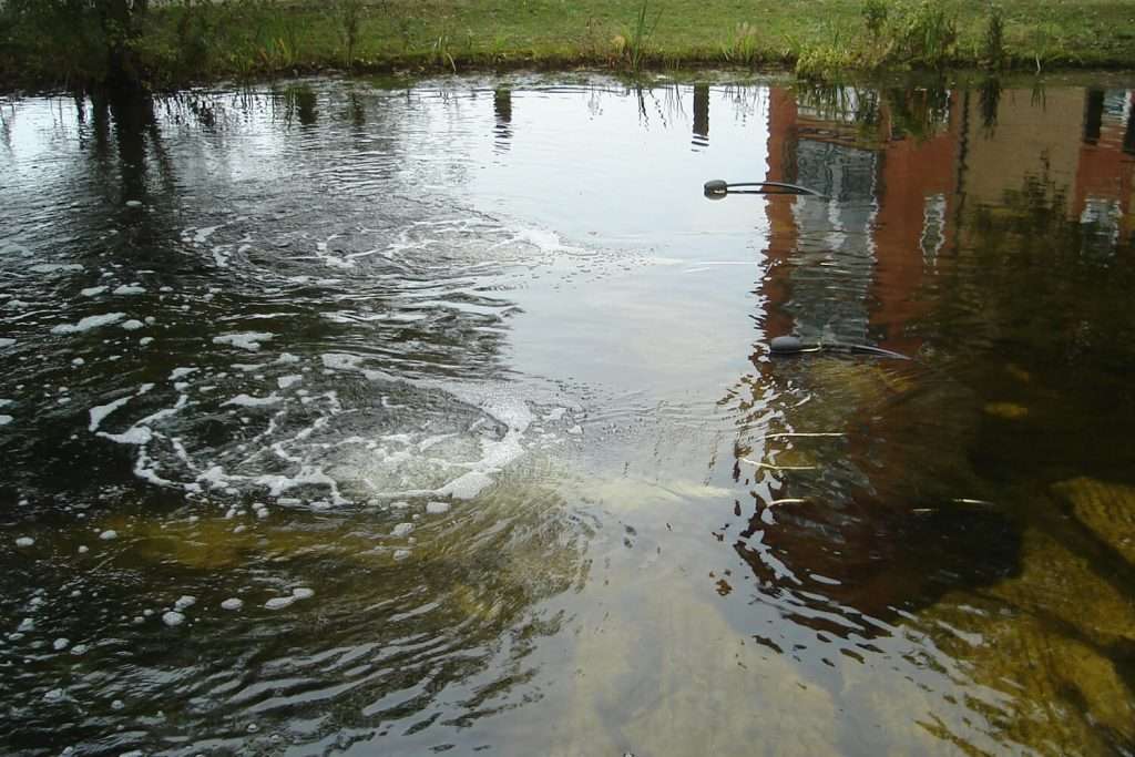 Otterbine Aspirator installed in residential pond delivering surface aeration