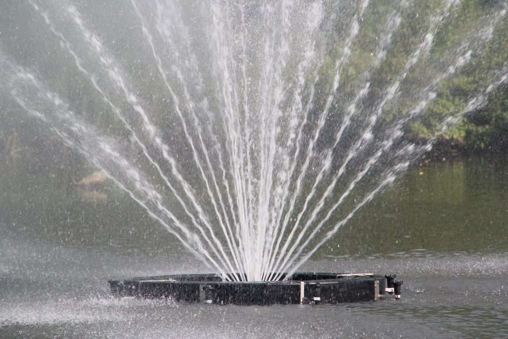 Close-up of Otterbine Equinox fountain base with multiple streams of water spraying upward