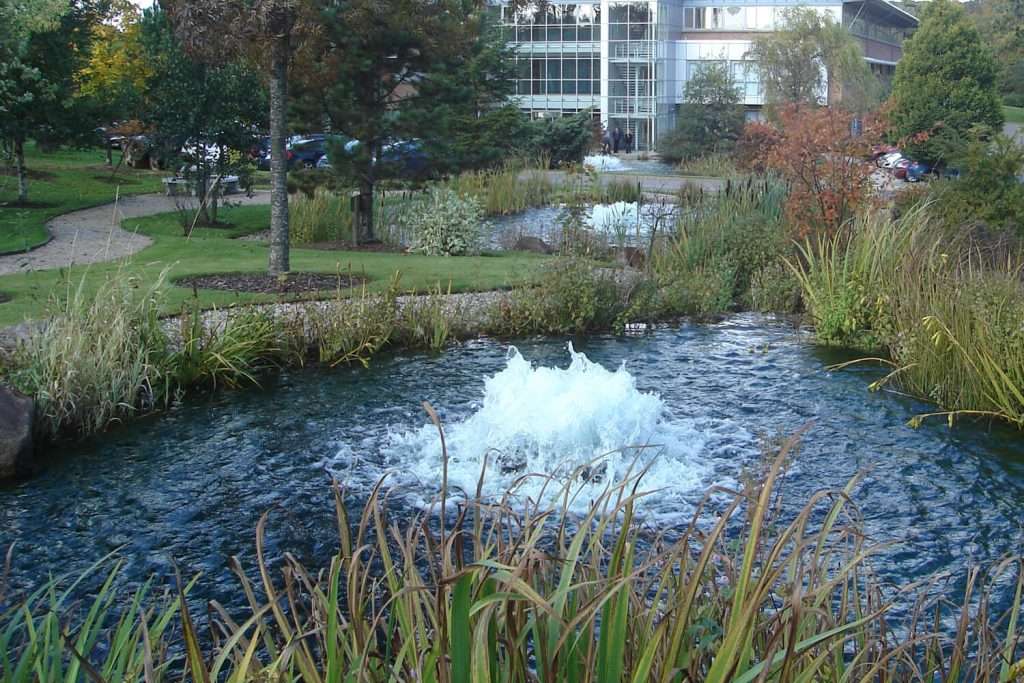 Otterbine High Volume fountain in landscaped water feature outside office building