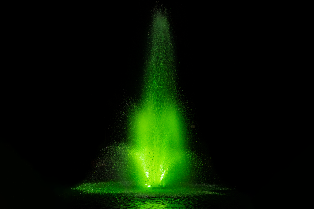 Otterbine MIDI-RGBW fountain highlighted with vivid lime green lighting in water spray