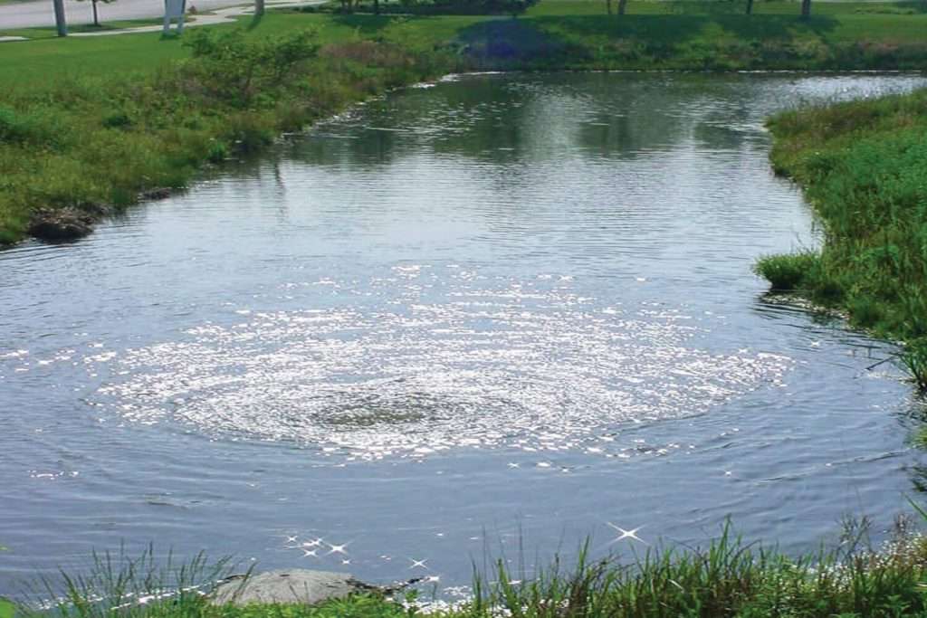 Otterbine Sub-Triton Mixer creating surface agitation in a pond