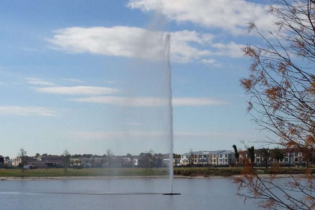 Otterbine Supernova fountain shooting a narrow jet of water high above a lake