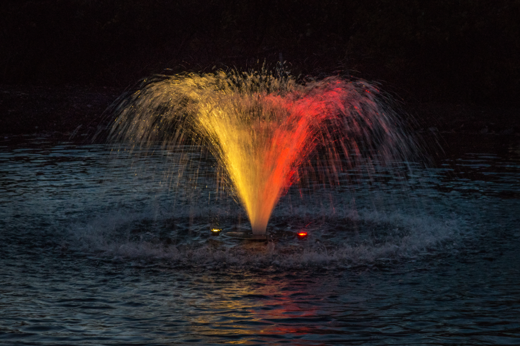 Otterbine Mini-RGBW fountain displaying yellow and red lighting effects over water