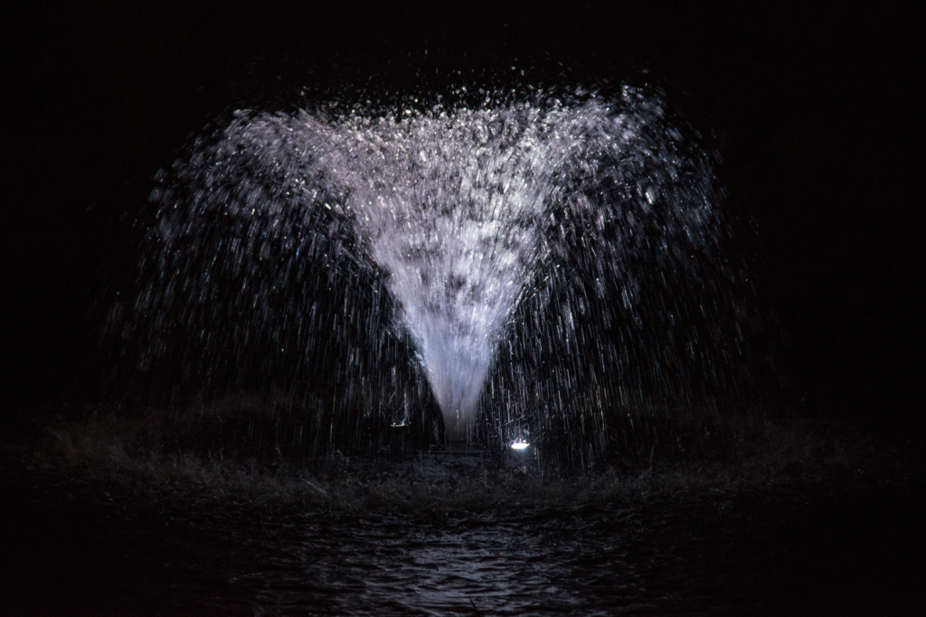 Otterbine Mini-RGBW fountain highlighted with bright white lighting in night setting